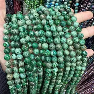 Close-up of green Imperial Jasper stone beads with natural mottled texture for DIY