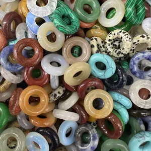 Collection of assorted colorful natural stone donut beads for DIY jewelry making and pendants