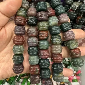 Close-up of colorful carved natural stone drum beads for DIY jewelry making
