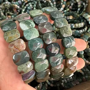 Detailed view of hand-held natural faceted Indian agate gemstone brick stretch bracelets