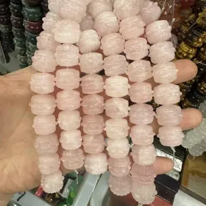 Close-up of carved pink rose quartz drum beads for DIY jewelry making