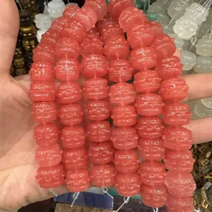 Close-up of pink carved drum-shaped natural agate beads for DIY jewelry making