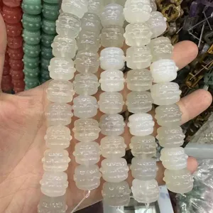 Macro view of carved drum-shaped translucent white natural stone beads for DIY jewelry
