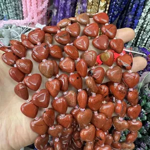 Close-up macro view of heart-shaped red jasper stone beads for DIY jewelry making craft