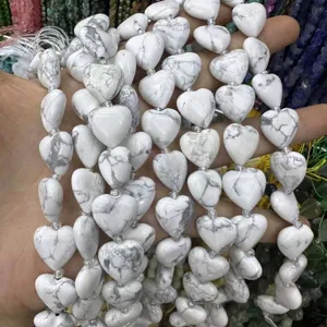 Close-up detail of white heart-shaped natural howlite stone beads for DIY jewelry making crafts