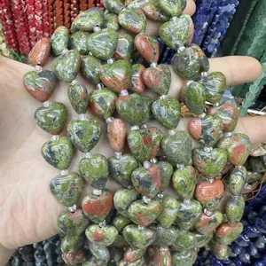 Close-up of heart-shaped green and pink unakite natural stone beads for DIY jewelry
