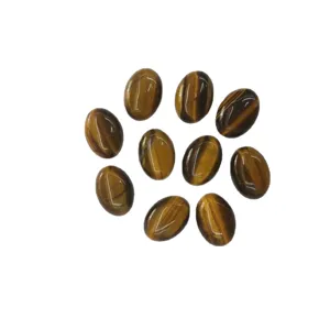 Cluster of natural tiger eye oval cabochons with golden brown chatoyancy on white background