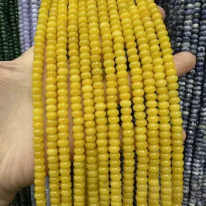 Macro detail of 4x6mm vibrant yellow abacus jade stone beads for DIY jewelry accessories