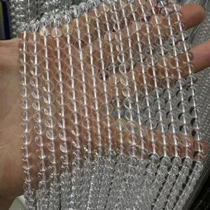 Macro detail view of clear natural white crystal round beads for DIY handmade jewelry crafts