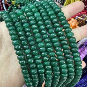Close-up macro shot of natural green faceted abacus stone beads for DIY jewelry making