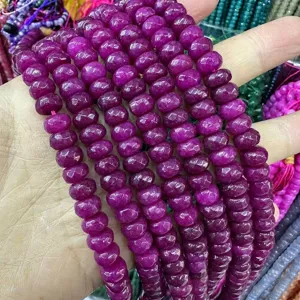 Close-up detail showing 5x8mm faceted magenta natural stone abacus beads for DIY jewelry