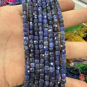 Detailed macro shot of 6mm faceted blue natural stone cube beads for DIY jewelry making