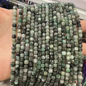 Macro view of 6mm faceted emerald green natural stone cube beads for DIY jewelry making