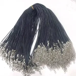 Close-up of black wax cord necklaces with silver lobster clasps for DIY jewelry making