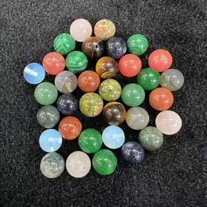 Detailed view of assorted natural crystal and agate stone round beads for DIY jewelry