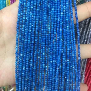 Macro view showing detail of 2mm blue round shell beads for DIY jewelry making crafts