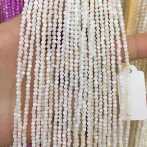 Close-up view of multiple strands of 2mm white round shell beads for DIY jewelry