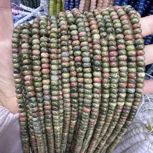 Close-up of 4x6mm green and pink unakite stone abacus beads for DIY jewelry making.