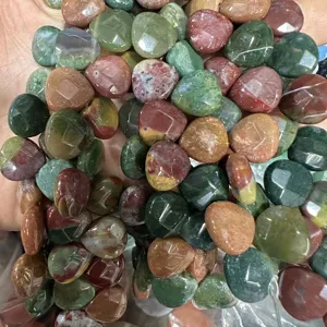 Detailed view of faceted heart-shaped natural stone beads showing texture and vibrant colors