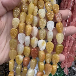 Close-up view of leaf-shaped natural stone beads in yellow and white tones for DIY jewelry