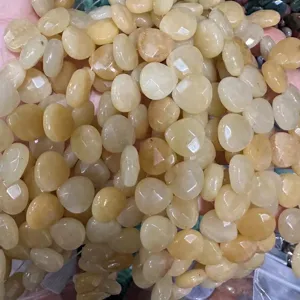 Detailed macro view of faceted creamy yellow natural stone teardrop beads for DIY jewelry making