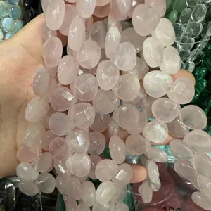 Close-up of faceted rose quartz teardrop beads for DIY jewelry making and accessories.