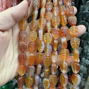 Close-up of natural leaf-shaped orange stone beads for DIY jewelry making accessories