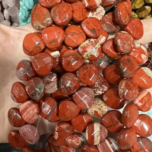 Close-up detail of natural faceted red jasper heart-shaped beads for DIY jewelry making