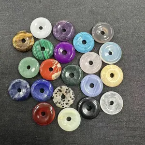 Detail view of 20mm natural stone donut beads in assorted colors like rose quartz and tiger eye.