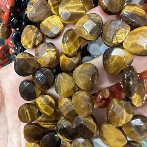 Close-up detail of faceted natural tiger eye heart-shaped beads for jewelry making