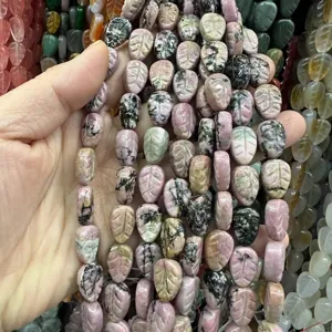 Detailed view of leaf-shaped pink rhodonite stone beads for custom jewelry design