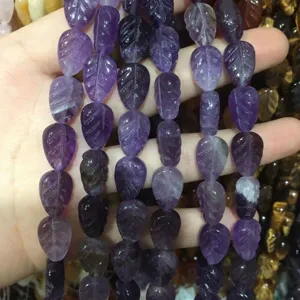 Macro detail of leaf-shaped purple amethyst stone beads for DIY jewelry accessories