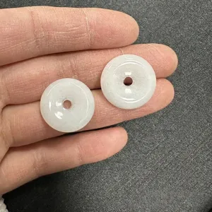Detailed view of two 20mm white natural stone donut pendant beads for DIY crafts