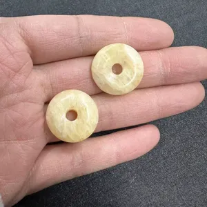 Macro view of 20mm pale yellow natural stone donut beads for DIY jewelry accessories