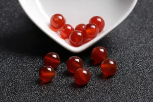 Macro view of natural polished red agate loose beads for DIY handmade jewelry crafting