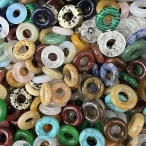 Detailed view of assorted natural agate and gemstone donut beads for DIY jewelry making