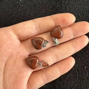 Makrodetail von 12mm natürlichen roten Jaspis herzförmigen Steinanhängern mit Metallösen