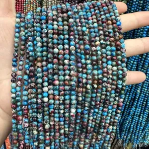 Macro view of blue sea sediment jasper round beads showing unique natural marble patterns
