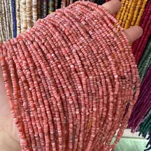 Macro detail of 3mm natural pink shell heishi spacer beads for handmade jewelry