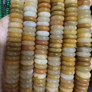 Macro detail of 4x12mm natural stone spacer beads showing varied colors and texture