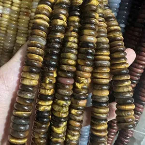 Macro view of 4x12mm natural tiger eye stone spacer beads with polished finish