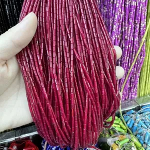Close-up of 2x4mm dark red cylindrical natural stone beads for DIY jewelry craft making