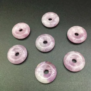 Detailed macro view of natural purple stone amethyst donut beads for jewelry making projects