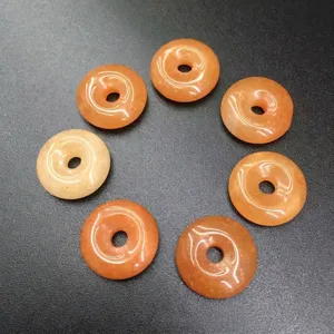 Close-up of 15mm natural orange stone Ping'an Kou donut beads for DIY jewelry making