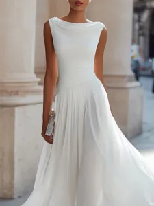 Close-up detail of elegant white cowl neck maxi dress with pleated flowing fabric design.
