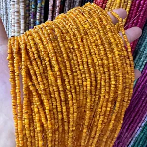 Close-up macro view of vibrant 3mm natural orange shell heishi beads for DIY jewelry making