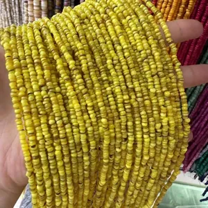 Macro detail of 3mm natural yellow shell spacer beads for DIY jewelry making accessories