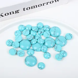 Detailed close-up of round turquoise cabochons with natural black matrix patterns for jewelry DIY.