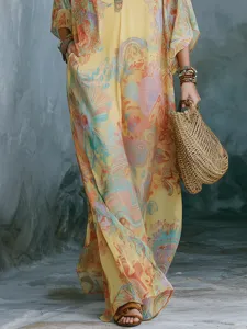 Close-up detail of women's bohemian floral print maxi dress, breezy summer resort kaftan style.