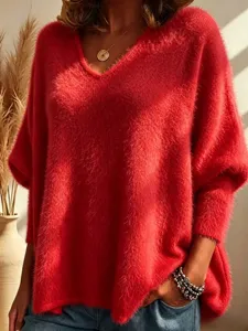 Close-up detail of the cozy red V-neck fluffy knit sweater showing soft textured fabric.